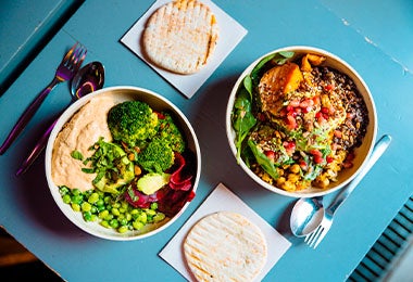 Dos platos de comida vegana servidos para el almuerzo. 